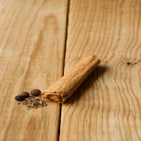 putting cinnamon to make coffee less bitter